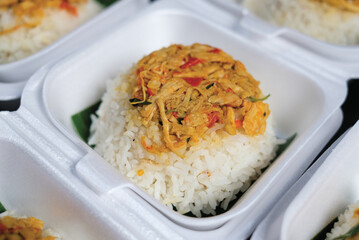 Boxed rice. Rows of packaged rice boxes, spicy seasoned shredded chicken.