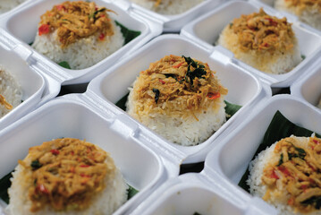 Boxed rice. Rows of packaged rice boxes, spicy seasoned shredded chicken.