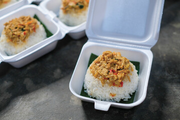 Boxed rice. Rows of packaged rice boxes, spicy seasoned shredded chicken.