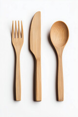 Bamboo cutlery, spoon, fork and knife. Non-plastic concept, environmental care and ecology. Isolated on white background.