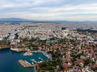 Obraz premium Aerial View of Residential District of City at Sea Coast. Old Town Marina in Small Bay. Antalya, Turkey.