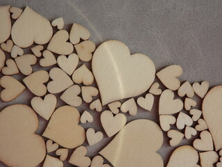 Obraz premium valentine's day greeting card-wooden hearts on a gray suede background. High quality photo