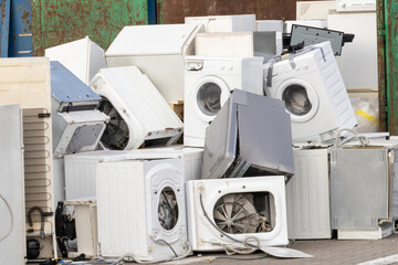 Pile of discarded household appliances for e-waste disposal