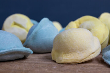 Cooking dumplings. Frozen, blue and yellow raw dumplings. Copy space for your advertisement and text