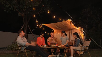 Family gather for holiday celebration in garden. Family member gather have dinner. Outdoor camping...