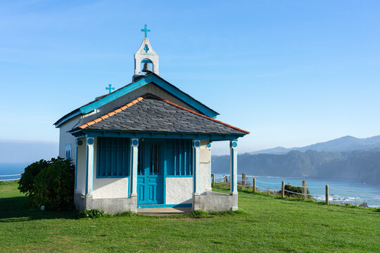 Hermitage of the Regalina with the typical Asturian horreos in Cadavedo, Asturias, Spain
