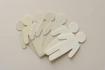 staggered pile of wood stick figures on beige paper