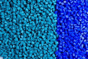 Blue and turquoise masterbatch granules on a white background, this polymer is a colorant for products in the plastics industry