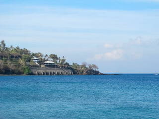 A view of beachfront villas overlooking the vast blue ocean, perfect for a family vacation or a getaway with loved ones