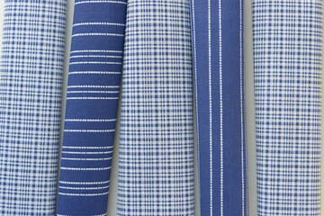 rolled fabric samples featuring blue and white patters
