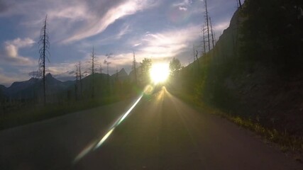 Driving into blinding sunlight on Going To The Sun Road at Glacier National Park, Montana, USA