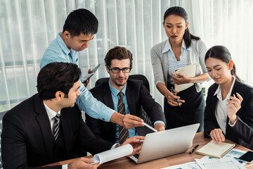 Diverse of business people from various ethnic group working in modern office environment. Productive and multi ethnic office workers engage in discussion for strategic business marketing. Meticulous