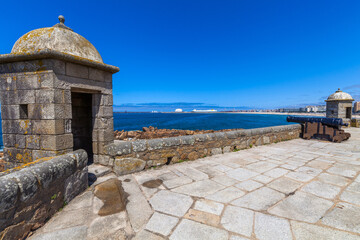 A historic coastal fort with stone turrets and cannons