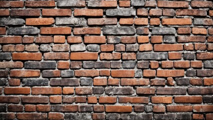 Obraz premium A textured wall made of various bricks in shades of red and gray.