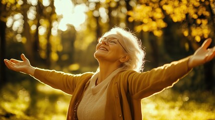 Senior woman with arms outstretched enjoying nature in park.