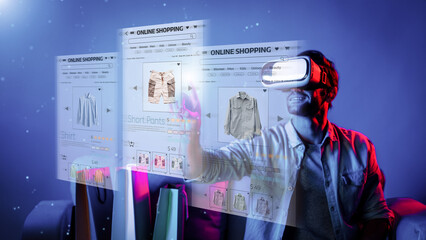 Caucasian man choosing and selecting product for shopping list while wearing visual reality goggles. Skilled person sitting at sofa with shopping bags while using VR glasses. Technology. Deviation.