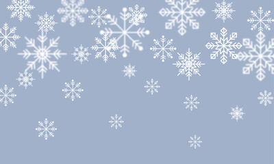 青い背景に浮かぶ様々な形の白い雪の結晶の背景