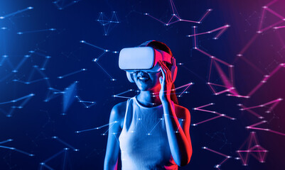 Female stand in cyberpunk neon light wear white VR headset and tank top connecting metaverse,...
