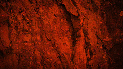 A striking red stone texture in 4K, featuring a rugged and grainy surface. Ideal for use as a background, wallpaper, banner, or creative backdrop