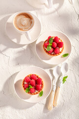 Homemade mini tart made of cream and raspberries.