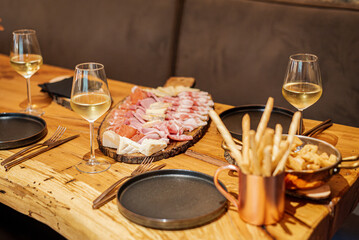 Elegant aperitivo around a huge charcuterie platter.