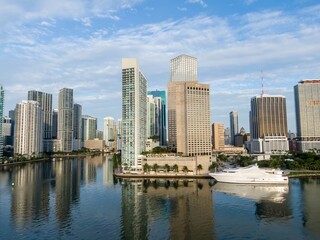 Fototapeta premium Downtown city skyline and calm ocean waterfront of Miami at sunrise, Florida, United States.