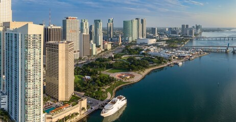 Fototapeta premium Downtown city skyline and calm ocean waterfront and Bayfront Park of Miami at sunrise, Florida, United States.