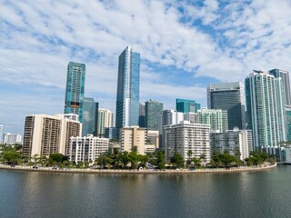 Fototapeta premium Downtown city skyline and calm ocean waterfront of Miami at sunrise, Florida, United States.