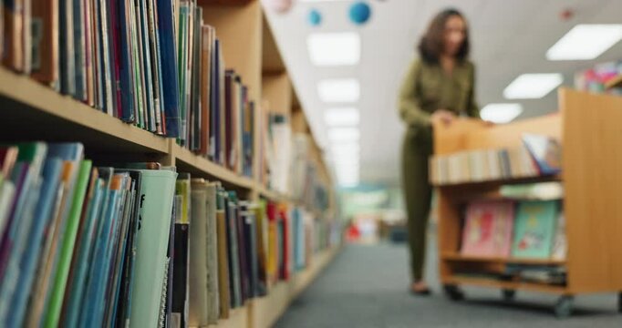 Woman, library and book shelf with cart for literature, novel or packing stock at bookstore. Female person, employee or librarian checking bookcase, inventory or rack with wooden trolley of knowledge
