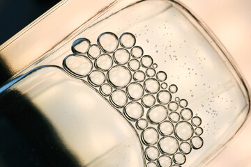 Shake the perfume and bubbles form as background