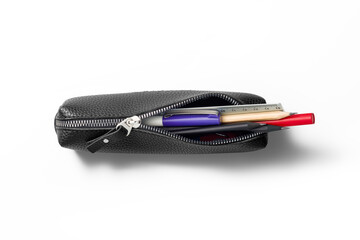 Top view opened pencil case containing various pens, markers, pencils, ruler and erasers isolated...
