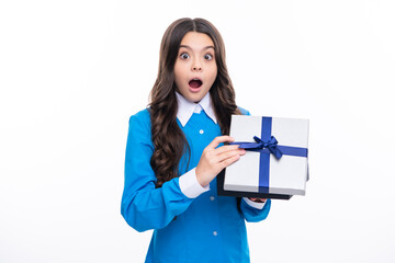 Emotional teenager child hold gift on birthday. Funny kid girl holding gift boxes celebrating happy New Year or Christmas. Surprised emotions of young teenager girl.