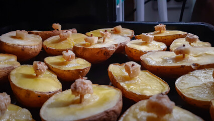 Baked potatoes in the oven.
Ruddy potatoes with a piece of lard on a match. A very tasty dish.