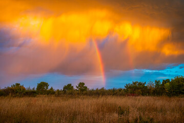 Rainbow sunrise with orange clouds