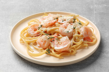 Delicious pasta with shrimps on grey table, closeup