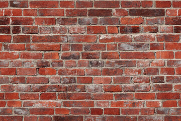 Fototapeta premium Red brick wall background with visible textures and patterns, perfect for creative projects or adding a nostalgic and timeless touch to any space.