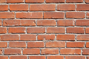Obraz premium Red brick wall background with visible textures and patterns, perfect for creative projects or adding a nostalgic and timeless touch to any space.