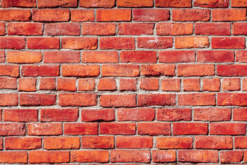 Obraz premium Red brick wall background with visible textures and patterns, perfect for creative projects or adding a nostalgic and timeless touch to any space.