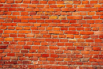 Red brick wall background with visible textures and patterns, perfect for creative projects or adding a nostalgic and timeless touch to any space.