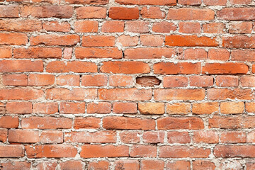 Obraz premium Red brick wall background with visible textures and patterns, perfect for creative projects or adding a nostalgic and timeless touch to any space.