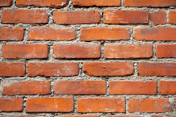 Obraz premium Red brick wall background with visible textures and patterns, perfect for creative projects or adding a nostalgic and timeless touch to any space.