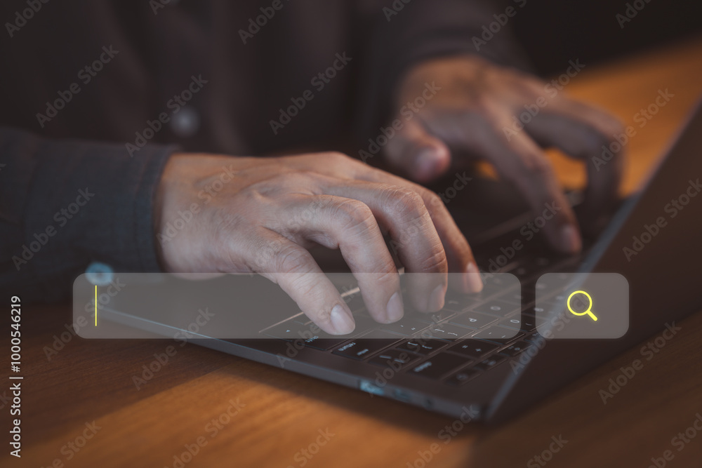 Poster person types on a laptop keyboard, focusing on a search bar with a magnifying glass icon. concept of