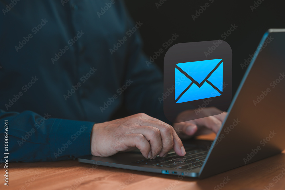 Poster person typing on a laptop with an email icon, symbolizing communication, digital correspondence, and