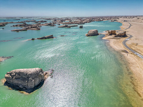 Yardang landforms and reflection in lake. Location: Wusute Yadan Geological Park, Qinghai, China.
