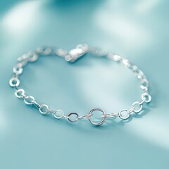Obraz premium Silver Chain Bracelet on Light Blue Background