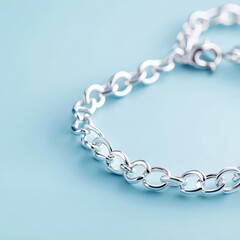 Obraz premium Elegant Silver Bracelet on Soft Blue Background