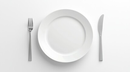 A simple table setting featuring a white plate, fork, and knife on a clean surface.