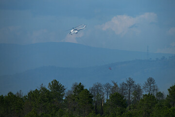 Fire fighting helicopter battling a wildfire in the Plaines des Maures, France
