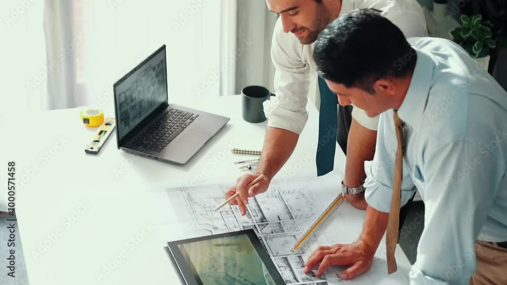 Poster top view of manager talk and discussing about house construction while sit and write at blueprint at