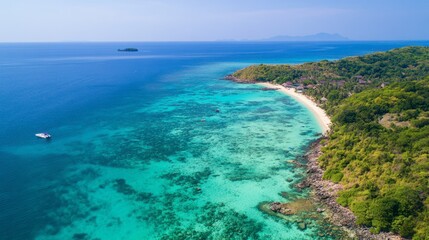 An aerial view of Koh Larns stunning coral reef just offshore, perfect for snorkeling and diving in clear blue waters.